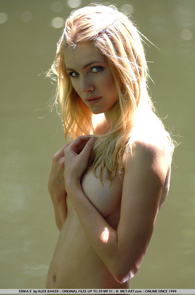 Adorable young blonde Erika E playing nude in and around a river